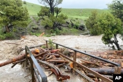 FILE - A bridge washed out from flooding at Rescue Creek in Yellowstone National Park, Mont., on June 13, 2022, is seen in this photo provided by the National Park Service.
