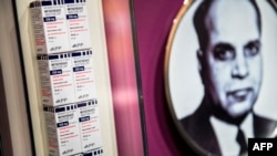 FILE - A photo of biochemist Yellapragada Subbarao is seen near boxes of methotrexate, which he developed, at the Smithsonian Museum of Natural History, Feb. 27, 2014, in Washington. A recent court ruling on abortion rights is affecting access to the drug.