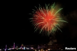 People celebrate the July 4th Independence Day holiday as fireworks explode over the San Diego County Fair, in Del Mar, California, U.S. July 4, 2022.