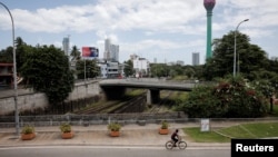 A man rides a cycle along main road as less vehicles are on the road due to fuel shortage, amid the country's economic crisis, in Colombo, Sri Lanka, June 28, 2022. 