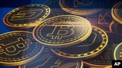 FILE - An advertisement of Bitcoin, one of the cryptocurrencies, is displayed 11.18.2021. Bitcoin and other cryptocurrencies collapsed in price on 6.13.2022 after the major crypto lender Celsius halted all withdrawals.