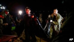 Federal police officers arrive at the pier with recovered human remains found during a search for Indigenous expert Bruno Pereira of Brazil and freelance reporter Dom Phillips of Britain, in Atalaia do Norte, Amazonas state, Brazil, June 15, 2022.