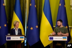 FILE - Ukraine President Volodymyr Zelenskyy speaks during a joint press conference with European Commission President Ursula von der Leyen, left, in Kyiv, Ukraine, June 11, 2022.
