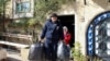 A charity's volunteer carries bags of humanitarian aid to be distributed to people in need, in Damascus, Syria, Jan. 30, 2022.