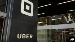 FILE - Signage is seen in front of the building that houses the headquarters of Uber, in San Francisco, California, June 21, 2017.