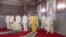 This image grab taken from footage provided by SNRT Maroc on July 10, 2022 shows King Mohammed VI praying on the first day of Eid al-Adha alongside his son, Crown Prince Moulay Hassan, and his brother, in the city of Sale. (Photo by SNRT Maroc / AFP) 