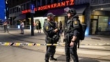 Security forces stand at the site where several people were injured during a shooting outside the London pub in central Oslo, Norway, June 25, 2022. 
