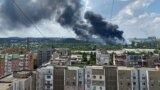 Smoke rises from the territory of an automotive center following recent shelling during Ukraine-Russia conflict in Donetsk, Ukraine, July 5, 2022. 