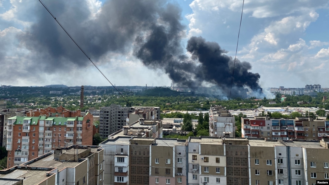 Smoke rises from the territory of an automotive center following recent shelling during Ukraine-Russia conflict in Donetsk, Ukraine, July 5, 2022. 