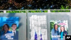 Electoral posters of presidential candidate Roxana Maracineanu and Rachel Keke are seen June 16, 2022 in Thiais, south of Paris.