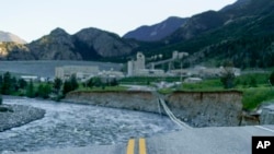 The main entrance to the Sibanye-Stillwater mine is cut off after the road was washed away by rising floodwaters in Nye, Mont., June 16, 2022.