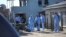 FILE: Forensic personnel investigate after the deaths of patrons found inside the Enyobeni Tavern, in Scenery Park, outside East London in the Eastern Cape province, South Africa, June 26, 2022. 