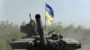 Ukrainian troop ride a tank on a road of the eastern Ukrainian region of Donbas on June 21, 2022, as Ukraine says Russian shelling has caused 'catastrophic destruction' in Lysychansk, which lies just across a river from Severodonetsk.