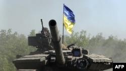 Ukrainian troop ride a tank on a road of the eastern Ukrainian region of Donbas on June 21, 2022, as Ukraine says Russian shelling has caused "catastrophic destruction" in Lysychansk, which lies just across a river from Severodonetsk.
