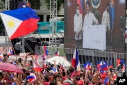 A screen shows incoming Philippine president Ferdinand Marcos Jr. and outgoing President Rodrigo Duterte at the inauguration ceremony venue at National Museum on Thursday, June 30, 2022 in Manila, Philippines. (AP Photo/Aaron Favila)