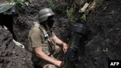 A Ukrainian serviceman mans a position in a trench on the front line near Avdiivka, Donetsk region, on June 18, 2022. 