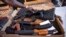 FILE - A G9 gang coalition member unpacks weapons in Port-au-Prince, Haiti, Oct. 6, 2021. A confrontation thought to be between the G9 and the GPEP gangs has led to dozens of deaths since July 8, 2022.