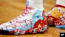 FILE - Former NBA player Enes Kanter Freedom, then with the Boston Celtics, wears shoes with a design in support of Uyghurs during a game against the Toronto Raptors, Nov. 10, 2021, in Boston. 