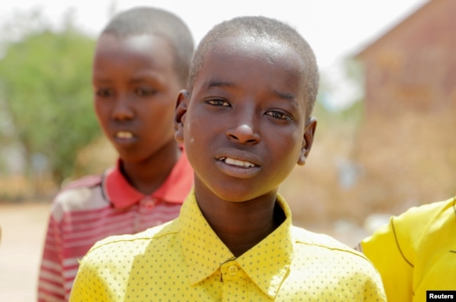 Bashir Nur Salat poses for a photograph with his classmates at the Kabasa Primary School in Dollow, Gedo Region, Somalia May 25, 2022. (REUTERS/Feisal Omar)