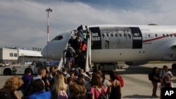 Ukrainian refugees board a plane before flying to Canada, from Frederic Chopin Airport in Warsaw, Poland, July 4, 2022. 