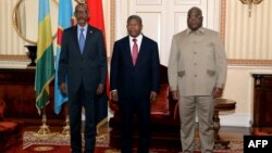 Rwanda President Paul Kagame, left, Angola President Joao Lourenco, center, and Democratic Republic of Congo President Felix Tshisekedi pose for a photograph in Luanda, Angola, on July 6, 2022, as they meet for talks after an upsurge in violence in eastern DRC. 