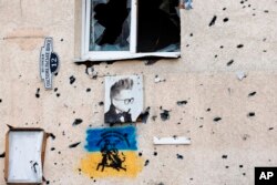 A Ukrainian national flag on a building in Irpin, June 16, 2022. (Associated Press)