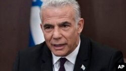 Israeli Prime Minister Yair Lapid speaks at the start of the the weekly Cabinet meeting in Jerusalem, July 10, 2022.