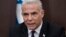 Israeli Prime Minister Yair Lapid speaks at the start of the the weekly Cabinet meeting in Jerusalem, July 10, 2022.