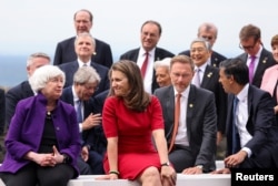 Canada's Finance Minister Chrystia Freeland and , U.S. Treasury Secretary Janet Yellen, left, , talk as they gather to pose for a photo during the G7 Summit in Koenigswinter, Germany on May 19, 2022.