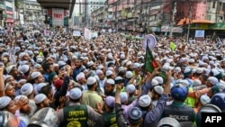 Police (foreground) stop activists and supporters as they try to march towards the Indian embassy in Dhaka on June 16, 2022, to protest against the remarks on the Prophet Mohammed by an India's ruling party official. 