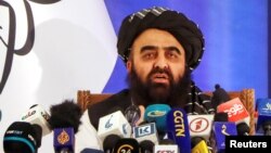 FILE - Taliban Foreign Minister Amir Khan Muttaqi speaks during a news conference in Kabul, Afghanistan, Sept. 14, 2021. Muttaqi urged the United States again, July 26, 2022, to lift sanctions and 'unconditionally' release some $7 billion in frozen Afghan central bank funds.