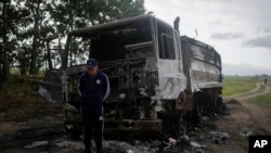 Vadym Schvydchenko stands next to his truck recently damaged by a mine on a dirt track near Makariv, on the outskirts of Kyiv, Ukraine, on June 14, 2022. The detonation of the 7.5-kilogram (16-pound) explosive charge destroyed the truck — and the livelihood — of Schvydchenko.