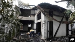 A man checks the debris of the burnt private residence of prime minister Ranil Wickremesinghe in Colombo, Sri Lanka, July 10, 2022.