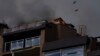 Birds fly over a residential building following explosions in Kyiv, Ukraine, June 26, 2022. 