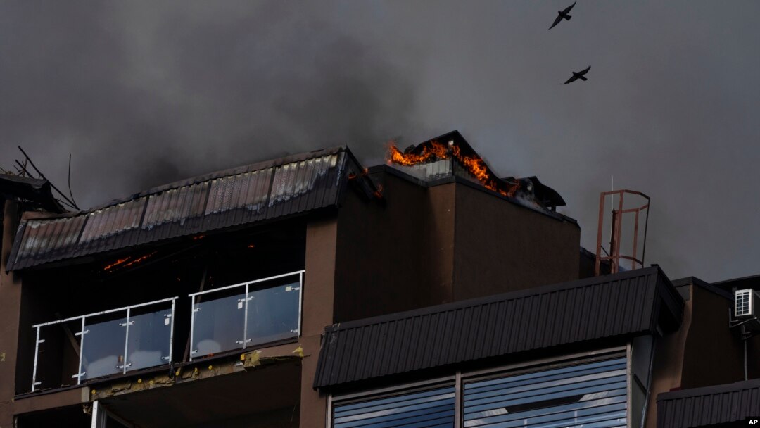 Birds fly over a residential building following explosions in Kyiv, Ukraine, June 26, 2022. 