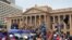 Protesters, many carrying Sri Lankan flags, gather outside the presidents office in Colombo, Sri Lanka, July 9, 2022.