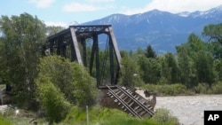 A collapsed train bridge is shown along the Yellowstone River, June 15, 2022, near Livingston, Montana.