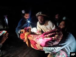 In this photo released by a state-run news agency Bakhtar, Afghans evacuate wounded in an earthquake in the province of Paktika, eastern Afghanistan, Wednesday, June 22, 2022. (Bakhtar News Agency via AP)