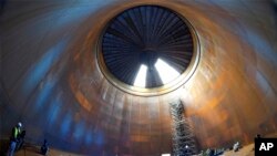 Journalist are seen inside a vast thermal tank to store hot water in Berlin, Germany.&nbsp;Power provider Vattenfall unveiled a new facility that turns solar and wind energy into heat, which can be stored in a vast thermal tank and released into the capital&#39;s grid as needed, smoothing out the fluctuating supply problem of renewables.