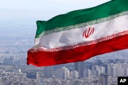FILE - Iran's national flag waves in Tehran, Iran, March 31, 2020.