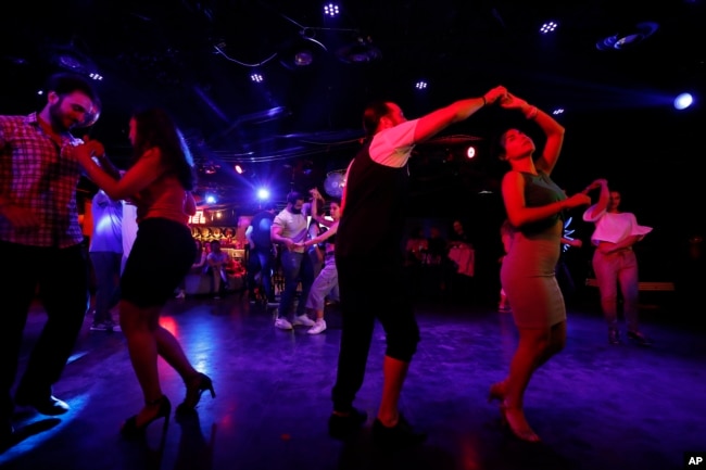 Couples dance at a club in Damascus, Syria, June 13, 2022. (AP Photo/Omar Sanadik)