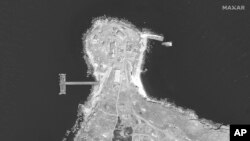 This WorldView-1 satellite black and white image from Maxar Technologies shows the northern end of Snake Island with burn marks in the Black Sea, on Tuesday, June 21, 2022.