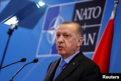 FILE - Turkish President Recep Tayyip Erdogan speaks during a news conference following a NATO summit, in Brussels, March 24, 2022.
