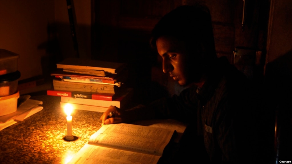 People have again resort to candlelight as power outages become common in Bangladesh. (Photo by Nazmul Islam)