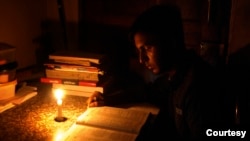 People have again resort to candlelight as power outages become common in Bangladesh. (Photo by Nazmul Islam)