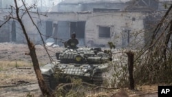 FILE - A Ukrainian tank is in position during heavy fighting on the front line in Sievierodonetsk, the Luhansk region, Ukraine, June 8, 2022.