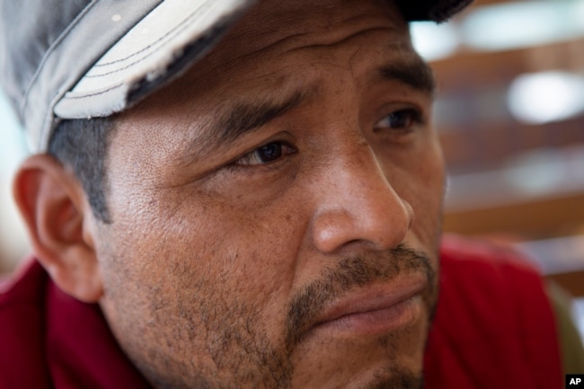 Mynor Cardona, Yenifer Yulisa Cardona Tomás' father, listens to a question during an interview in Guatemala City, Monday, July 4, 2022. (AP Photo/Oliver de Ros)
