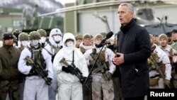 FILE - NATO Secretary-General Jens Stoltenberg addresses the troops as part of a military exercise called "Cold Response 2022," gathering around 30,000 troops from NATO member countries plus Finland and Sweden.