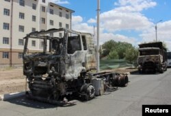 Trucks burnt during protests are seen during a government-organized press visit in Nukus, capital of the northwestern Karakalpakstan region, Uzbekistan, July 6, 2022.
