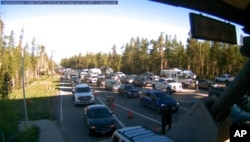 Traffic is backed up at the West Entrance gate at Yellowstone National Park in Montana, June 22, 2022, in this photo provided by National Park Service.
